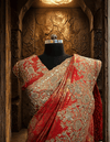 Close-up profile of the rust color tissue pallu draping over the model's shoulder, highlighting the clean, hand-finished sequence border.