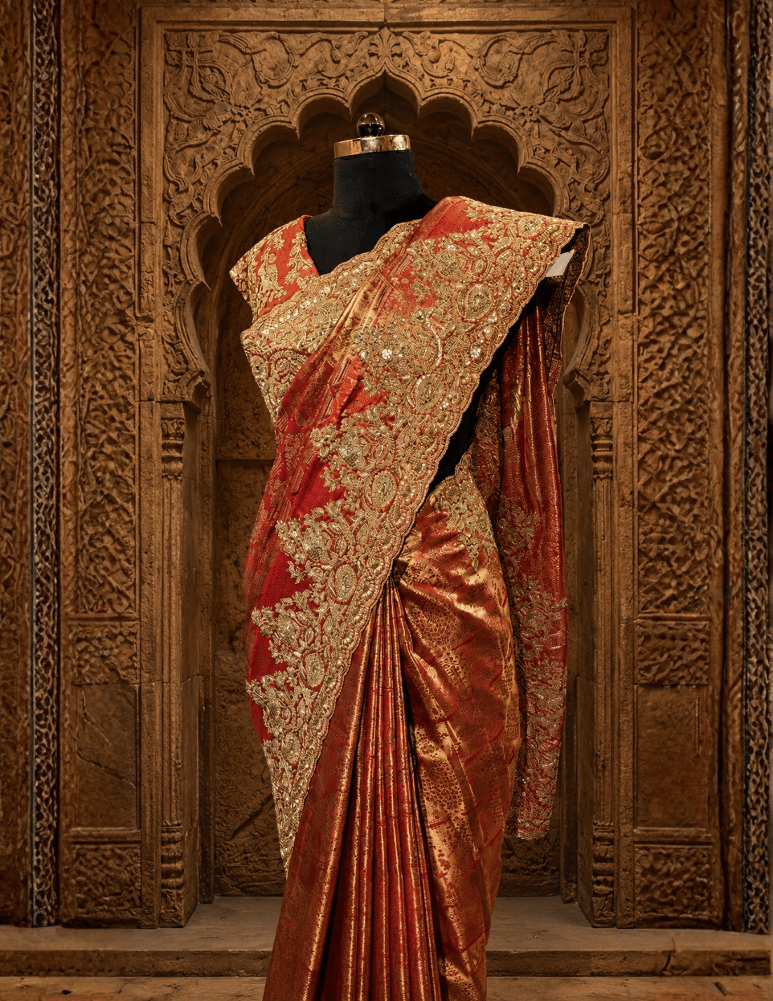 Elegant back profile of the rust tissue saree look showing its graceful pleats, fluid drape, and the stylish tie-up design of the matching blouse.