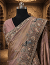 Elegant back profile of the draped lavender tissue saree, showcasing its graceful pleats, metallic sheen, and clean border finish.