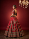 Back profile of the red lehenga bride outfit, highlighting the massive flare and the detailed craftsmanship of the blouse.