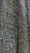 Close-up macro shot of the mauve net fabric showcasing the detailed layout of hand-sewn silver kardana cut beads and matching sequins.