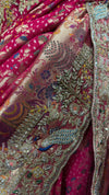 Close-up macro shot of the rani pink fabric highlighting the intricate tie-dye patterns, hand-sewn glass kardana beads, and shimmering jarkan crystals.