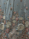 Close-up macro shot of the sky blue tissue fabric highlighting the detailed pastel resham threads, shining glass kardana beads, and white pearl clusters.