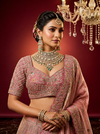 Close-up of a peacock motif on a pink colour lehenga featuring intricate Dabka and Resham thread work.
