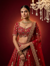 Close-up of red color lehenga embroidery showing multi-Resham flowers and white pearl accents.
