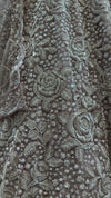 Detailed profile of the lehenga skirt's lower border panels, highlighting the wave-like patterns of shimmering sequence work.
