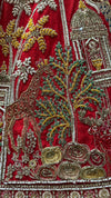 Detailed view of the lehenga border showing a mix of colorful thread work, stones, and shimmering sequins.