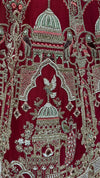 Detailed view of the lehenga's border featuring intricate floral thread work, stones, and shimmering sequins on a red base.