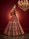 Elegant back profile of the red lehenga for women, showcasing the grand flare and the detailed craftsmanship of the bridal blouse.