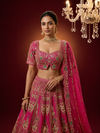 Front profile of a model showcasing the light pink lehenga blouse with a sweetheart neckline and heavy stone and thread embroidery.