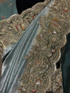A macro close-up view focusing on the saree's cutwork border, detailing the shimmering silver sequence, hand-aligned kardana glass beads, and micro-pearl trims surrounding ornate floral patterns.