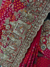 A macro close-up image showcasing the intricate cutwork border, highlighting rows of tiny white pearls, gleaming kardana work, and miniature figurative embroidery details.