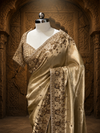 A three-quarter view from the side highlighting how the metallic Tissue fabric drapes elegantly over the shoulder, accentuating the thick hand-embroidered sequin border.
