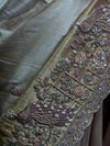 A macro texture detail shot highlighting the magnificent peacock embroidery on the border, featuring precisely aligned white pearls, metallic cut beads, and sparkling jarkan stones.
