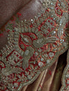 A macro photograph of the scalloped border detailing the artisan peacock motif, lavishly adorned with shimmering silver sequins, metallic cut beads, and fine golden embroidery contours.