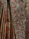 A detailed look at the vertical folds of the tissue silk fabric, highlighting the contrast between the fluid, shimmering rust-gold body covered in red floral prints and the highly structured, heavily encrusted scalloped border.