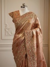 A medium portrait view highlighting the upper bodice of the mannequin, showcasing how the opulent scalloped border overlays the coordinated rust-toned heavily embroidered blouse.