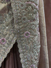 A composite macro photograph capturing the dense artisan craftsmanship, showing fine details of the scalloped border with its silver sequins, cluster pearls, circular motifs, and pink resham-embroidered flower centers.
