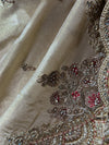 Detailed shot of the tissue silk fabric folds, revealing scattered hand-embroidered floral bootis with pink silk thread centers.
