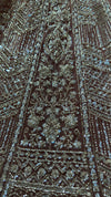 Close-up of the lehenga skirt's panel design, showing the geometric layout of shimmering cut beads on the delicate mesh base.