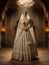 Portrait view of the model showcasing the matching light grey choli with a wide neckline framed in dense cut bead borders.