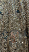  Detailed view of the lehenga's lower panel, showing the intricate geometric and floral thread work interspersed with shimmering beads.