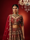 Luxury silk red lehenga with intricate nakshi and zardozi detailing
