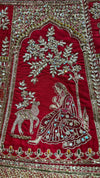 Macro shot of the lehenga border showcasing a dense arrangement of stones, cut beads, and shimmering sequins.