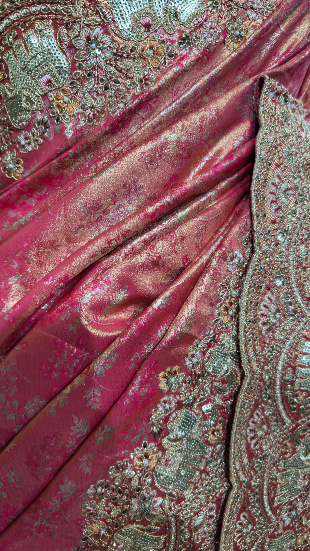 Macro view of the matching blouse fabric revealing a dense floral lattice pattern made of gold zari and tightly packed crystals.