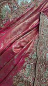 Macro view of the matching blouse fabric revealing a dense floral lattice pattern made of gold zari and tightly packed crystals.