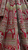 Portrait view of the bride highlighting the heavily embellished choli and the intricate handwork on the red wedding lengha.