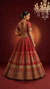 Stunning red bridal lehenga displayed to show the voluminous flare and traditional manual work.