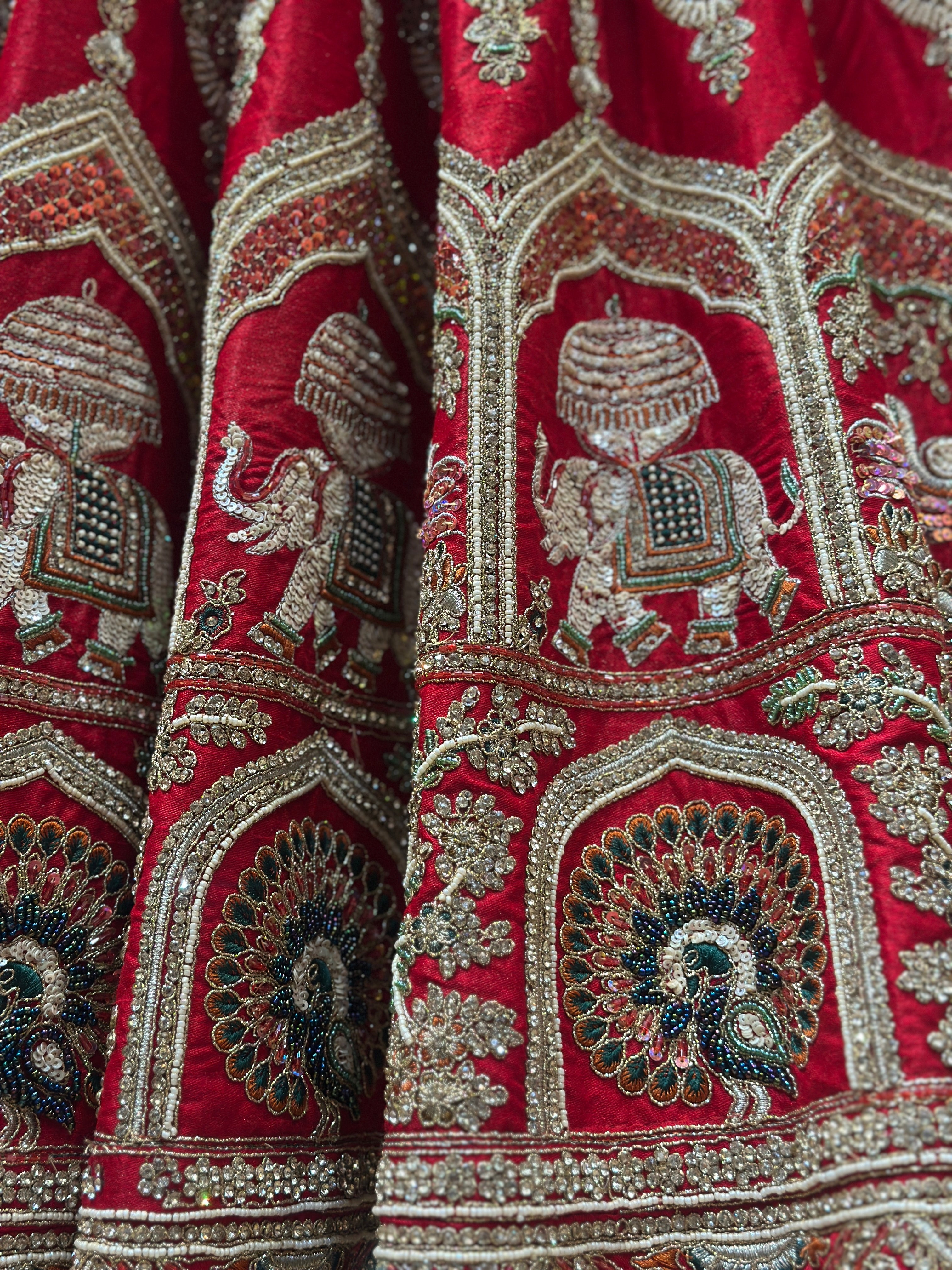 Traditional royal red silk lehenga for bride with intricate work
