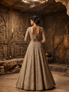 Portrait shot of the model highlighting the matching beige golden choli with a wide sweetheart neckline framed in heavy beadwork borders.