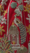 A breathtaking side profile of the red color bridal lehenga highlighting the voluminous flare and rich embroidery.