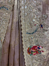Detailed profile of the saree's border work, showcasing the wave-like layouts of glittering sequence lines and delicate pink resham thread flowers.