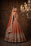 Rust silk bridal lehenga with heavy zardozi embroidery and dupatta
